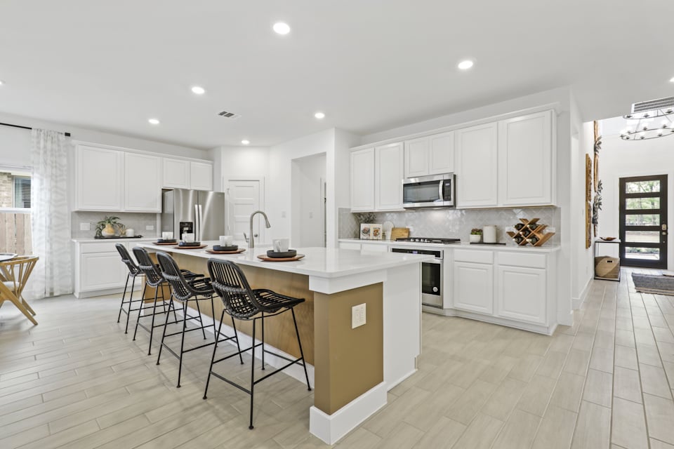 A kitchen with white cabinets.