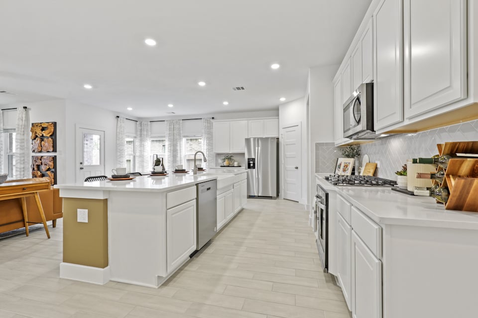 A kitchen with white cabinets.