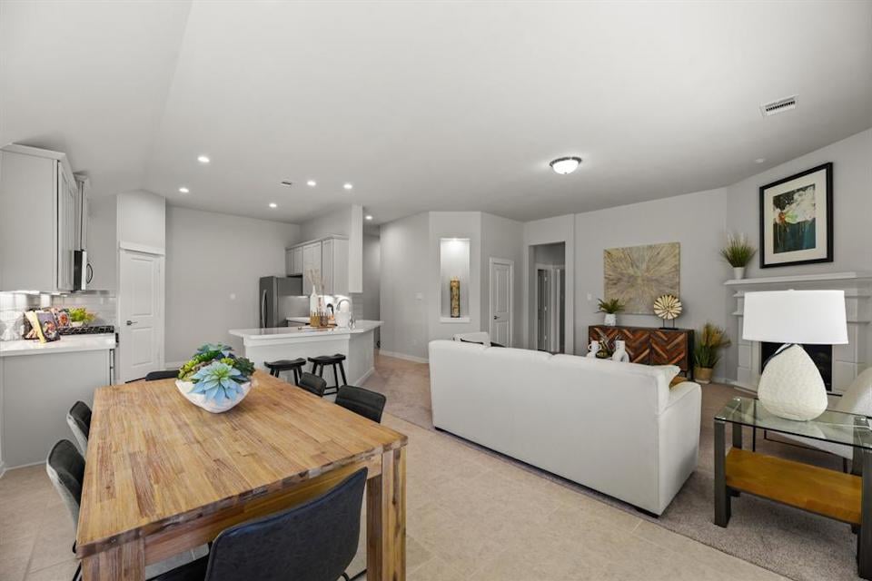 A large living room with a dining table and couches.