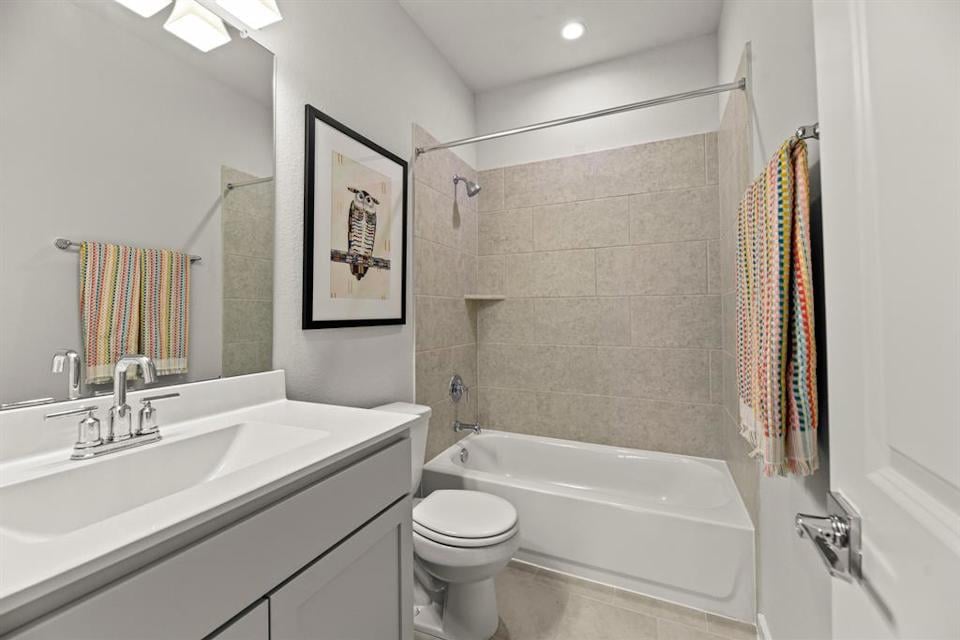 A bathroom with a tub sink and toilet.