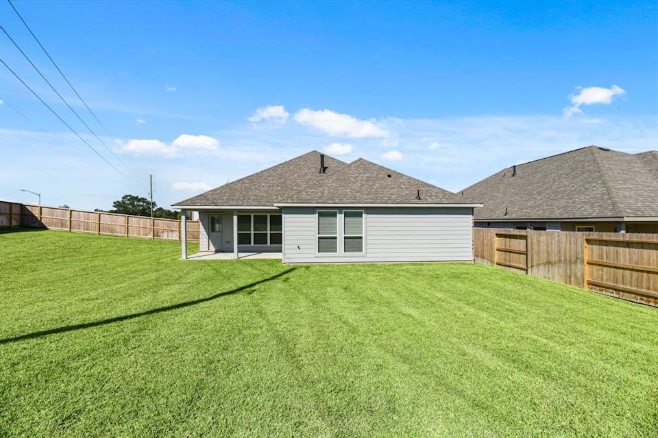 A house with a fence and grass.