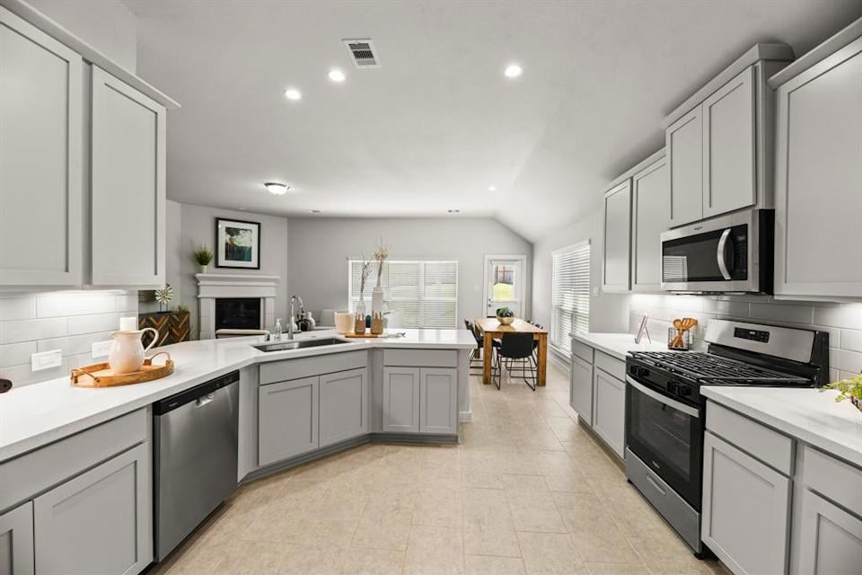 A kitchen with white cabinets.