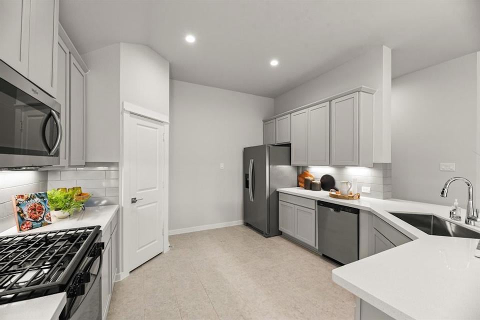 A kitchen with white cabinets.