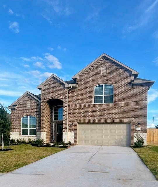 A brick house with a garage.