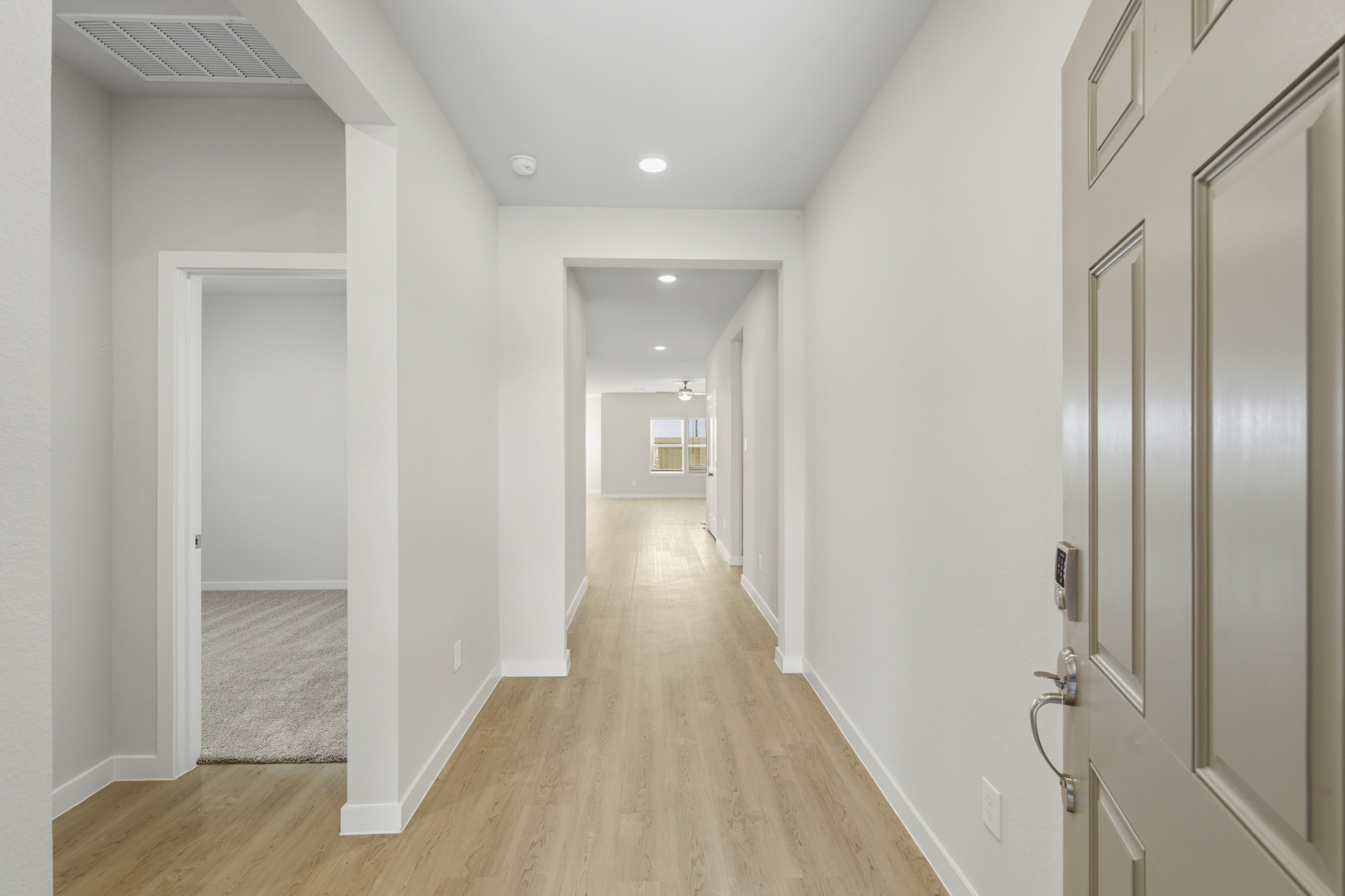 A hallway with white walls.