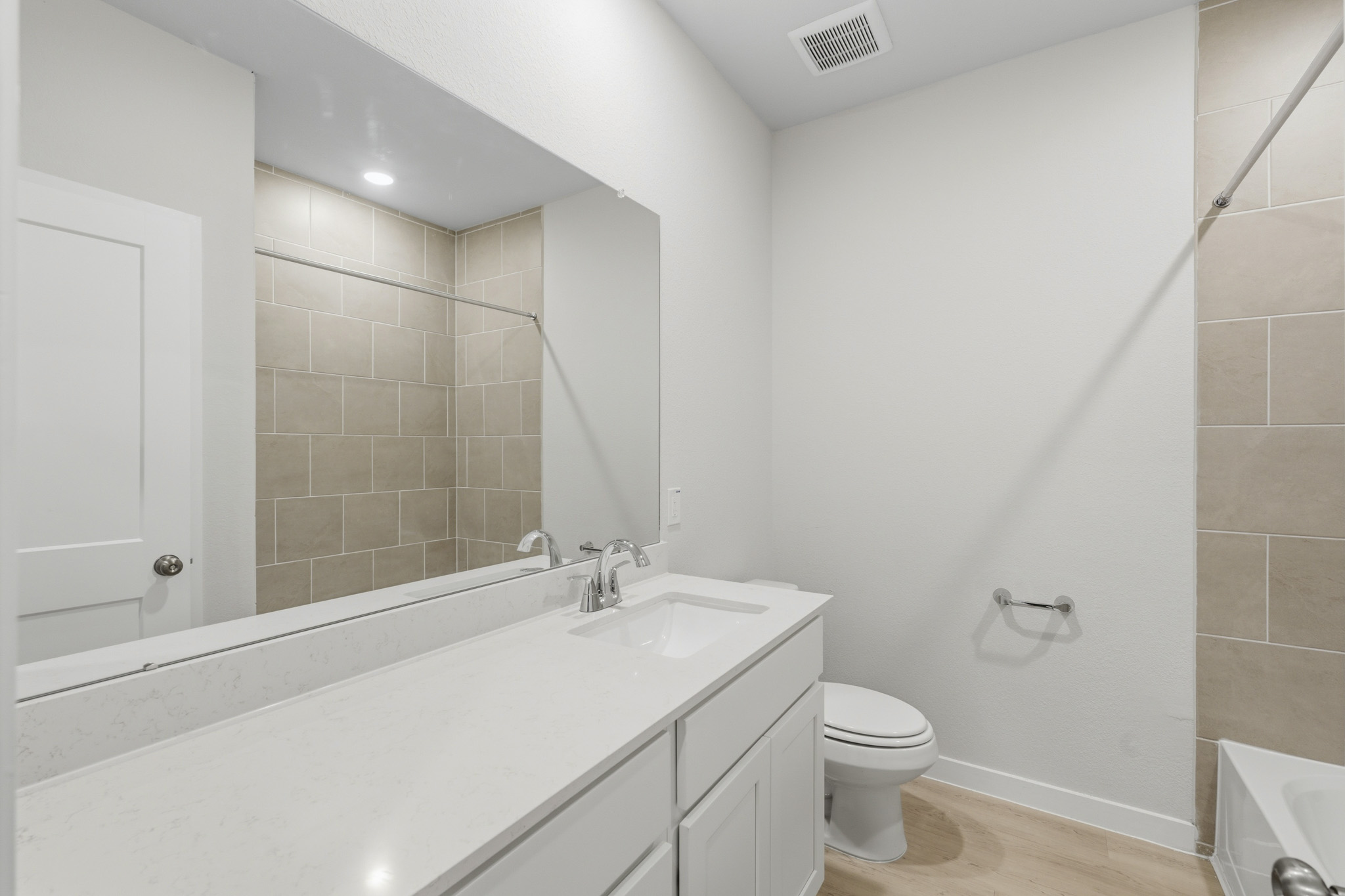 A bathroom with a tub toilet and sink.