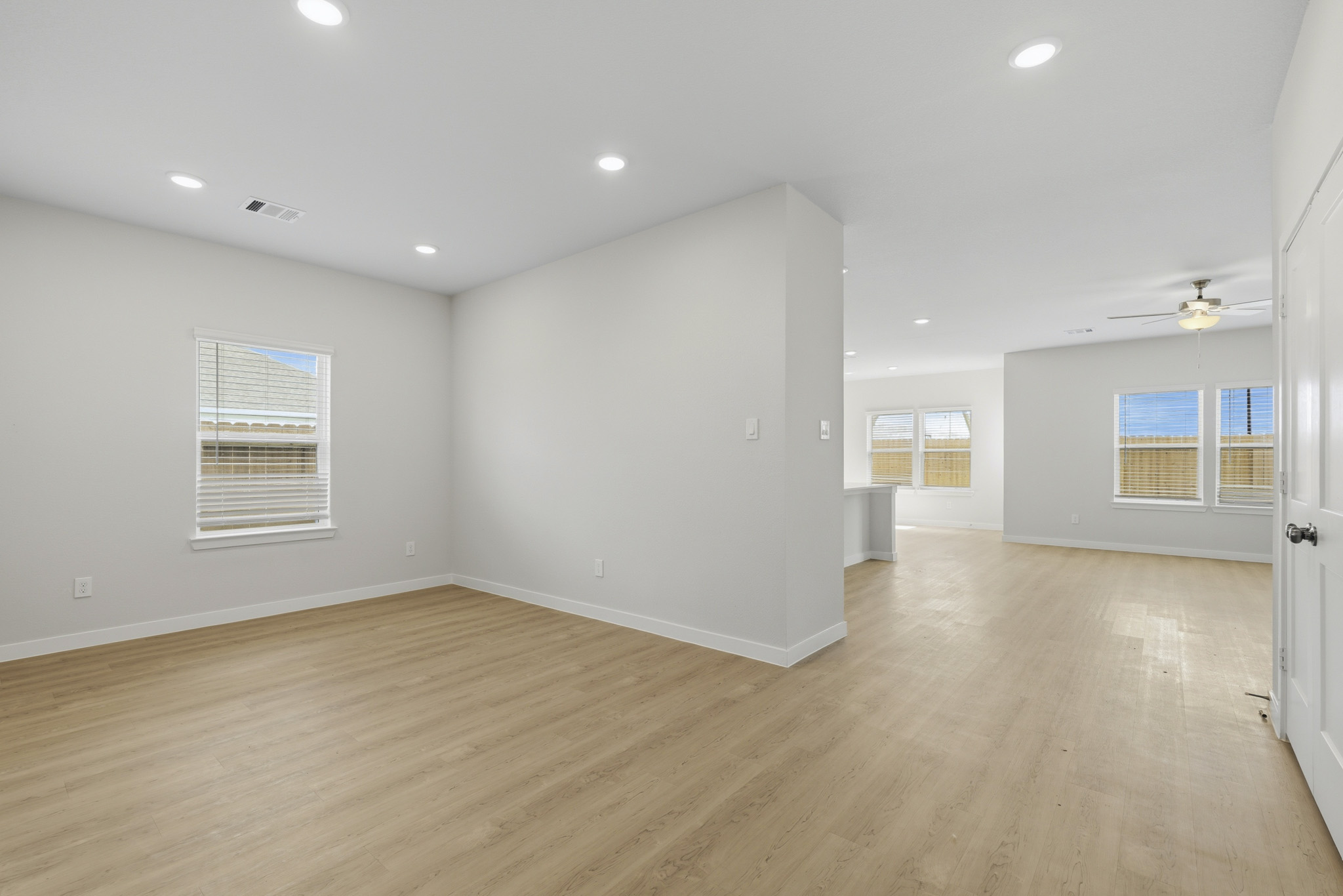 A room with a wood floor and white walls.