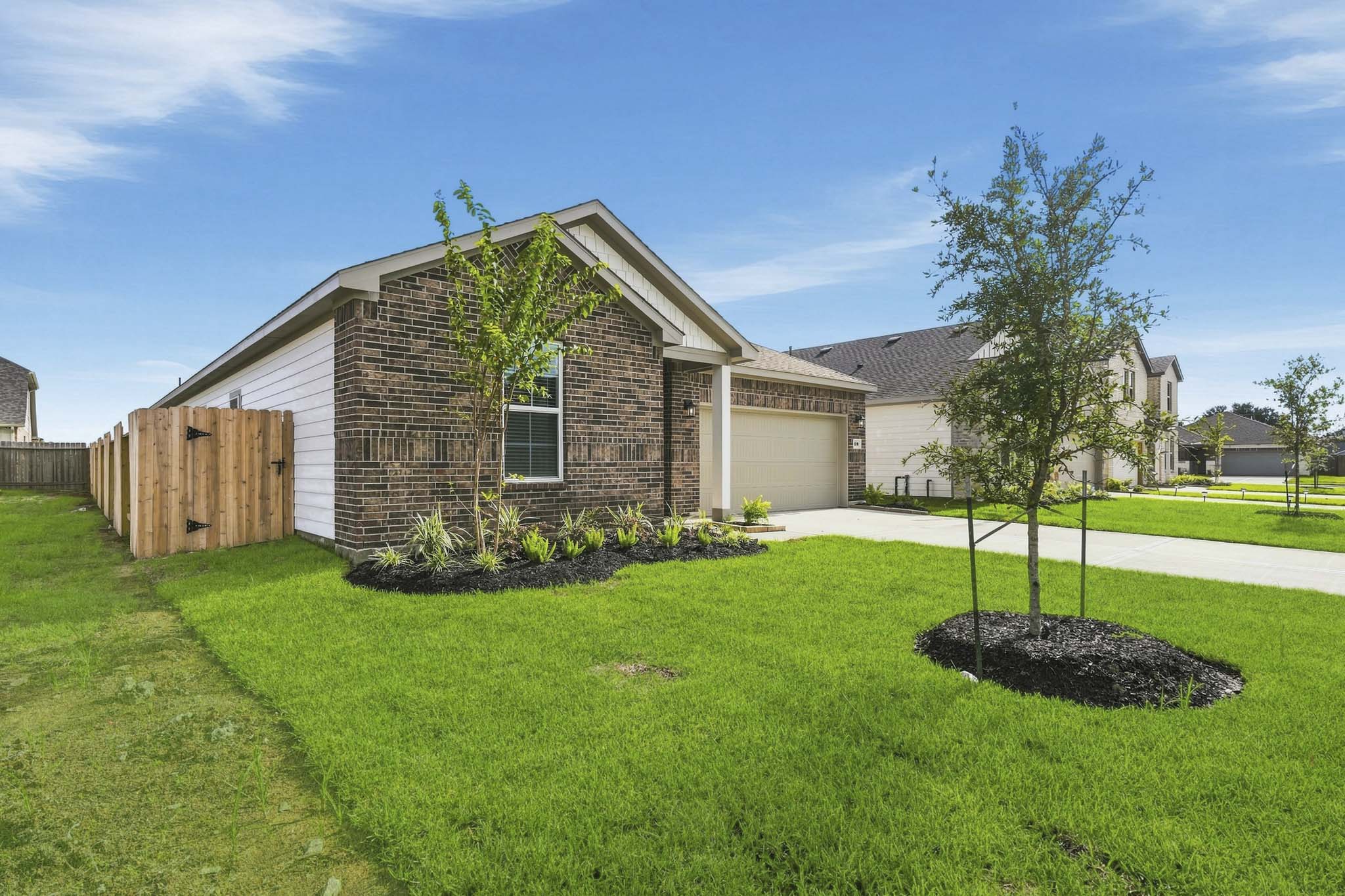 A house with a tree in the front yard.