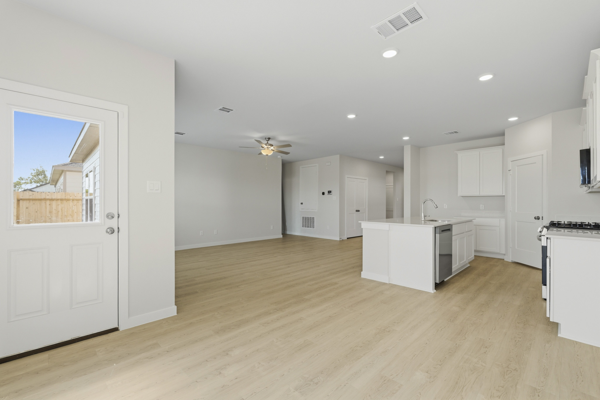 A large kitchen with white cabinets.