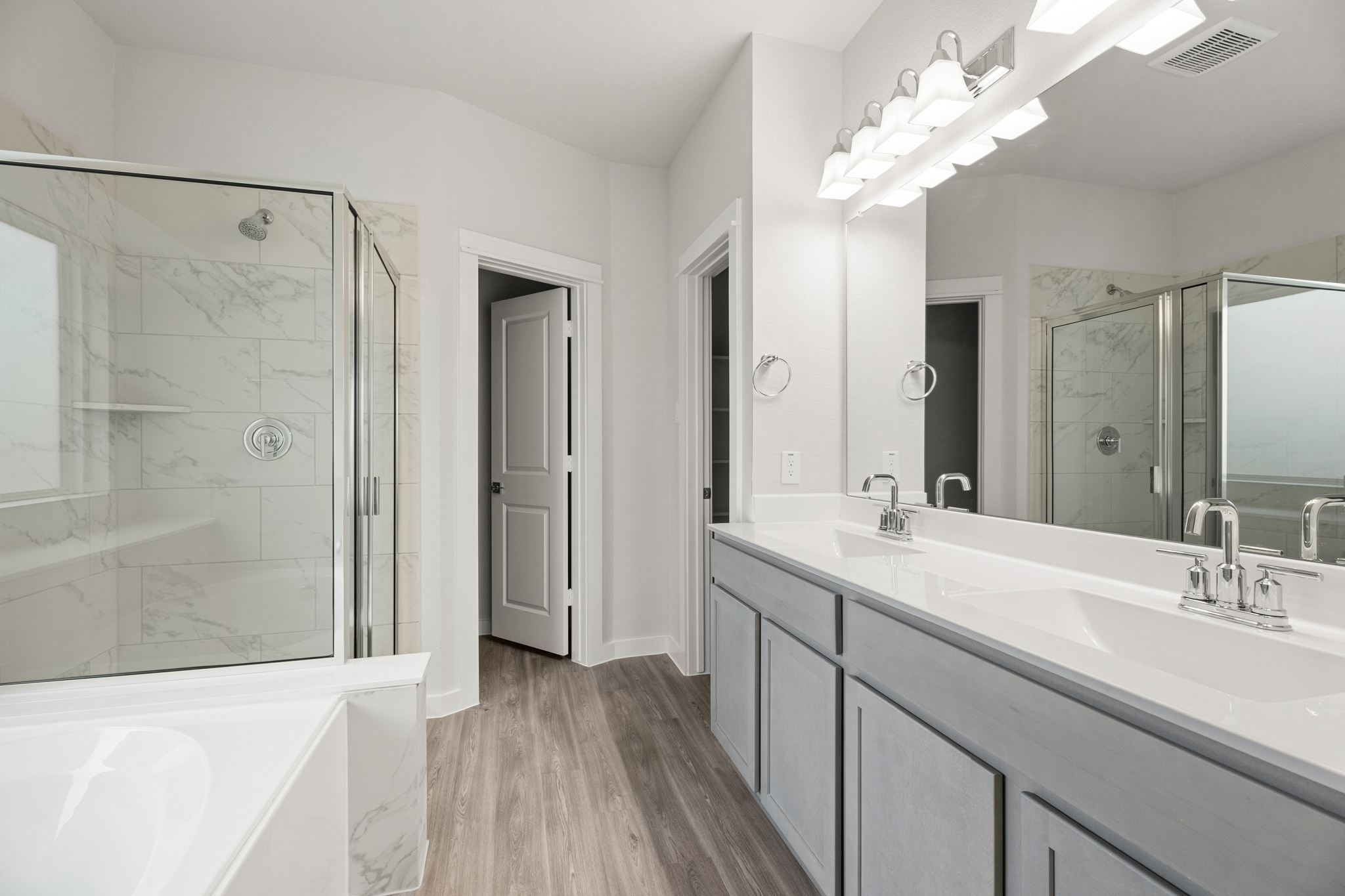 A bathroom with a large mirror.