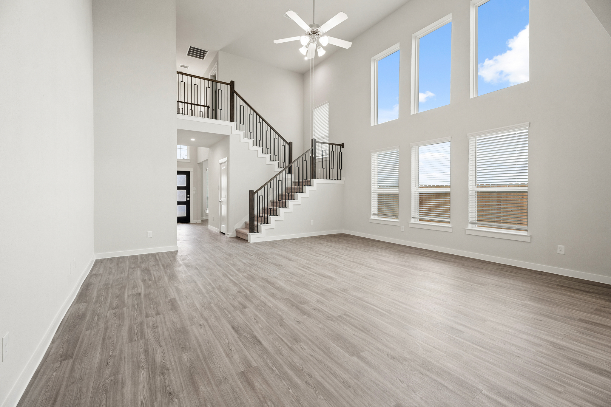 A large empty room with a wood floor and a wood floor.