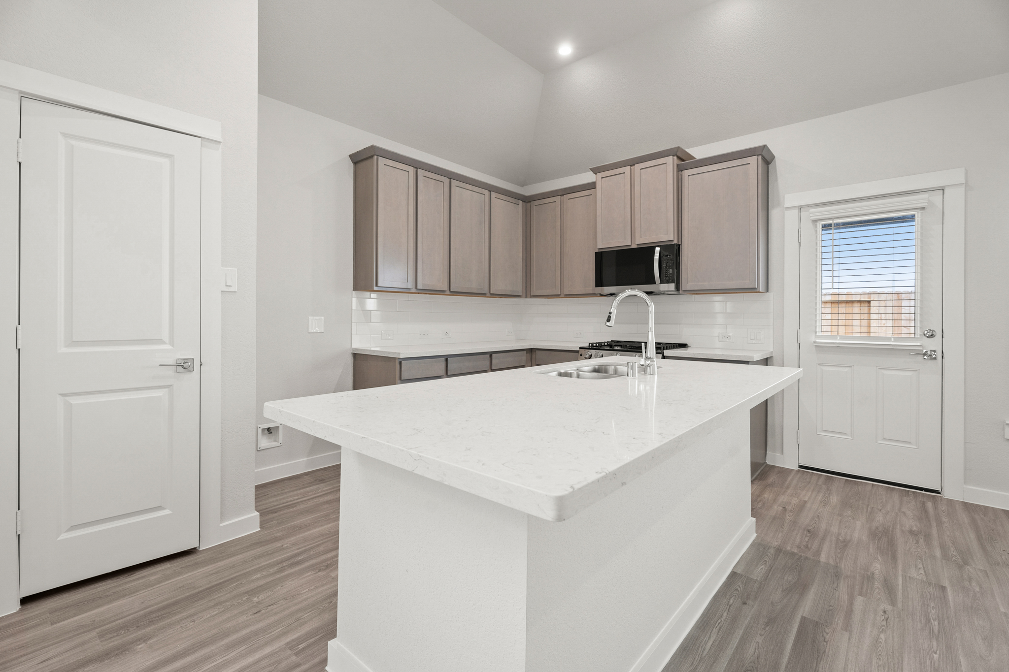 A kitchen with white cabinets.