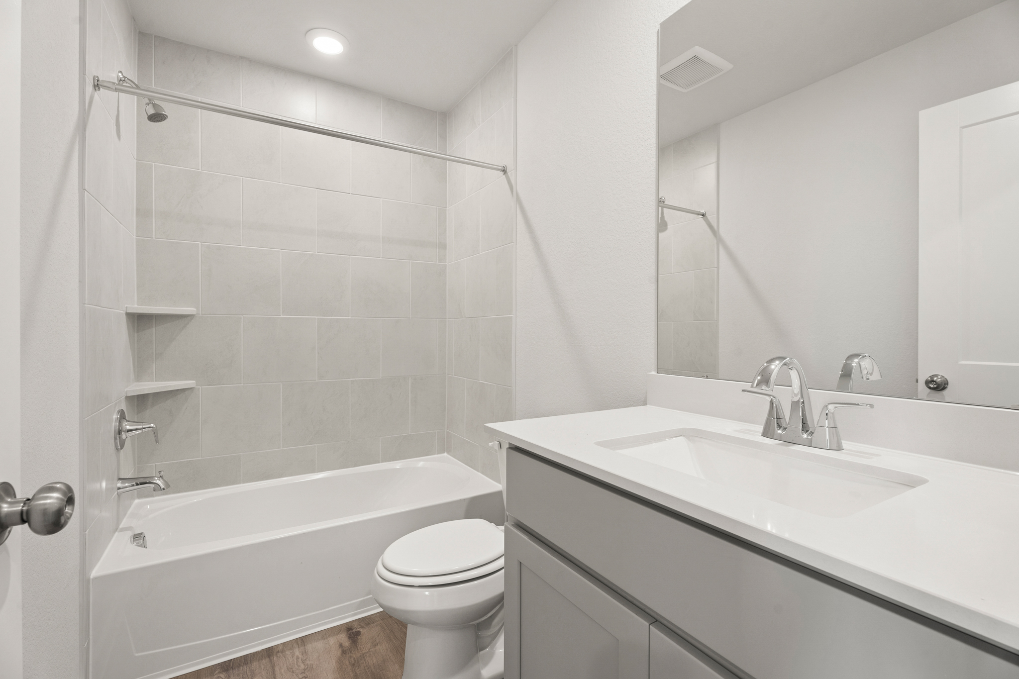 A bathroom with a tub sink and toilet.