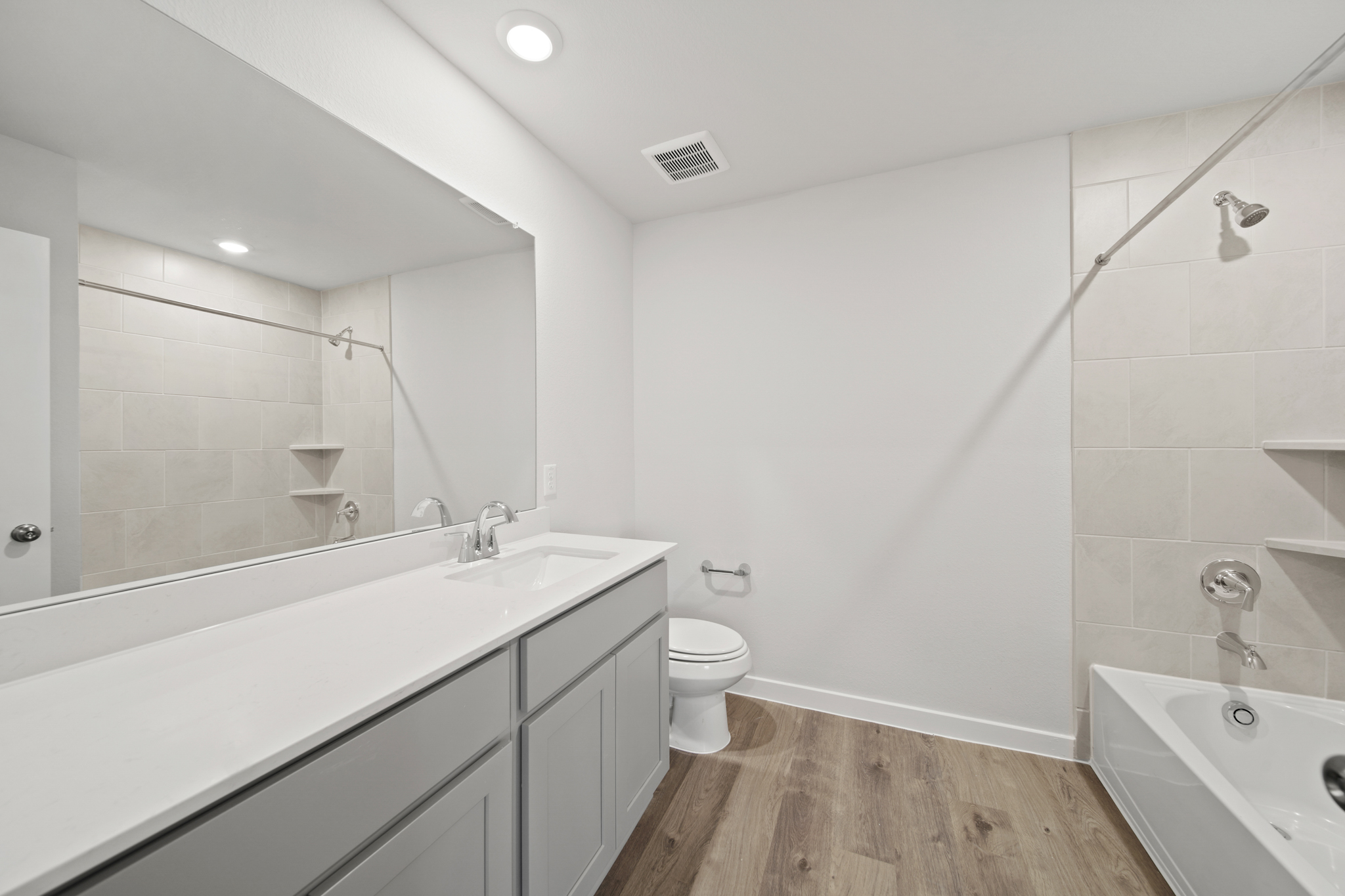 A bathroom with a tub toilet and sink.