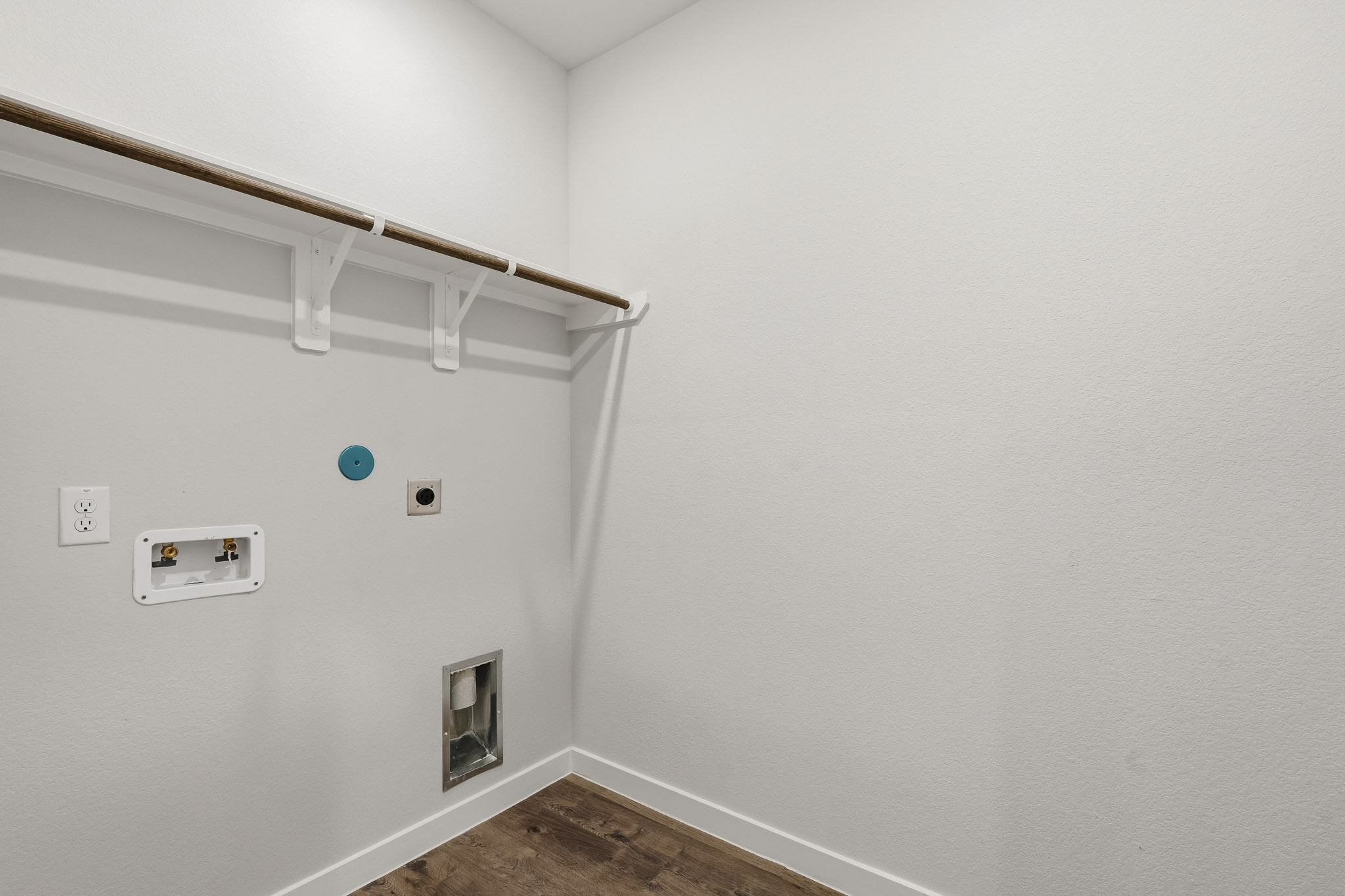 A white wall with a light fixture.