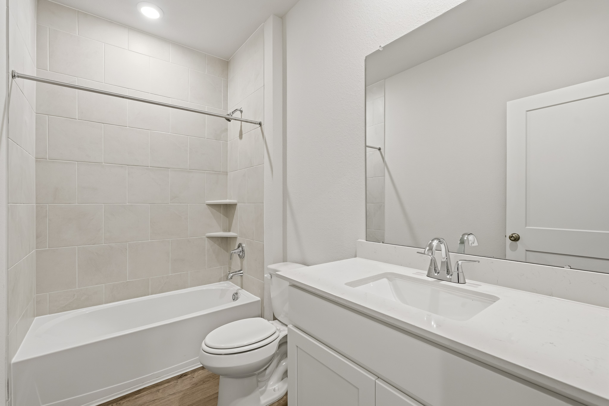 A bathroom with a tub sink and toilet.
