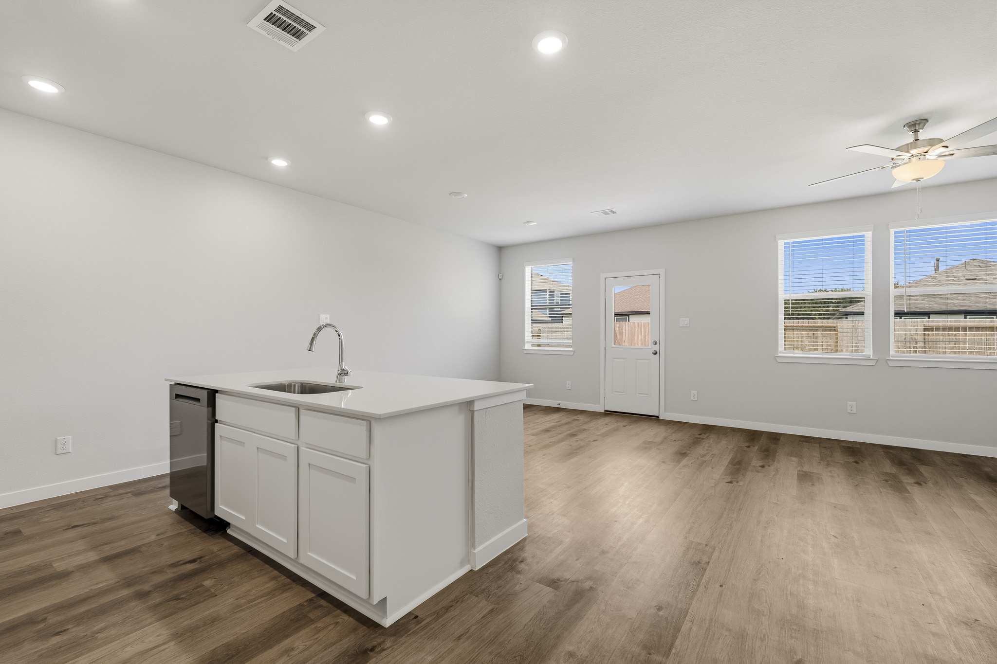 A kitchen with white cabinets.