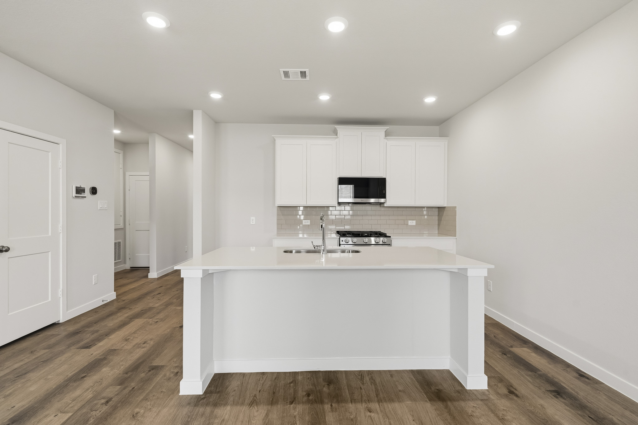 A kitchen with white cabinets.
