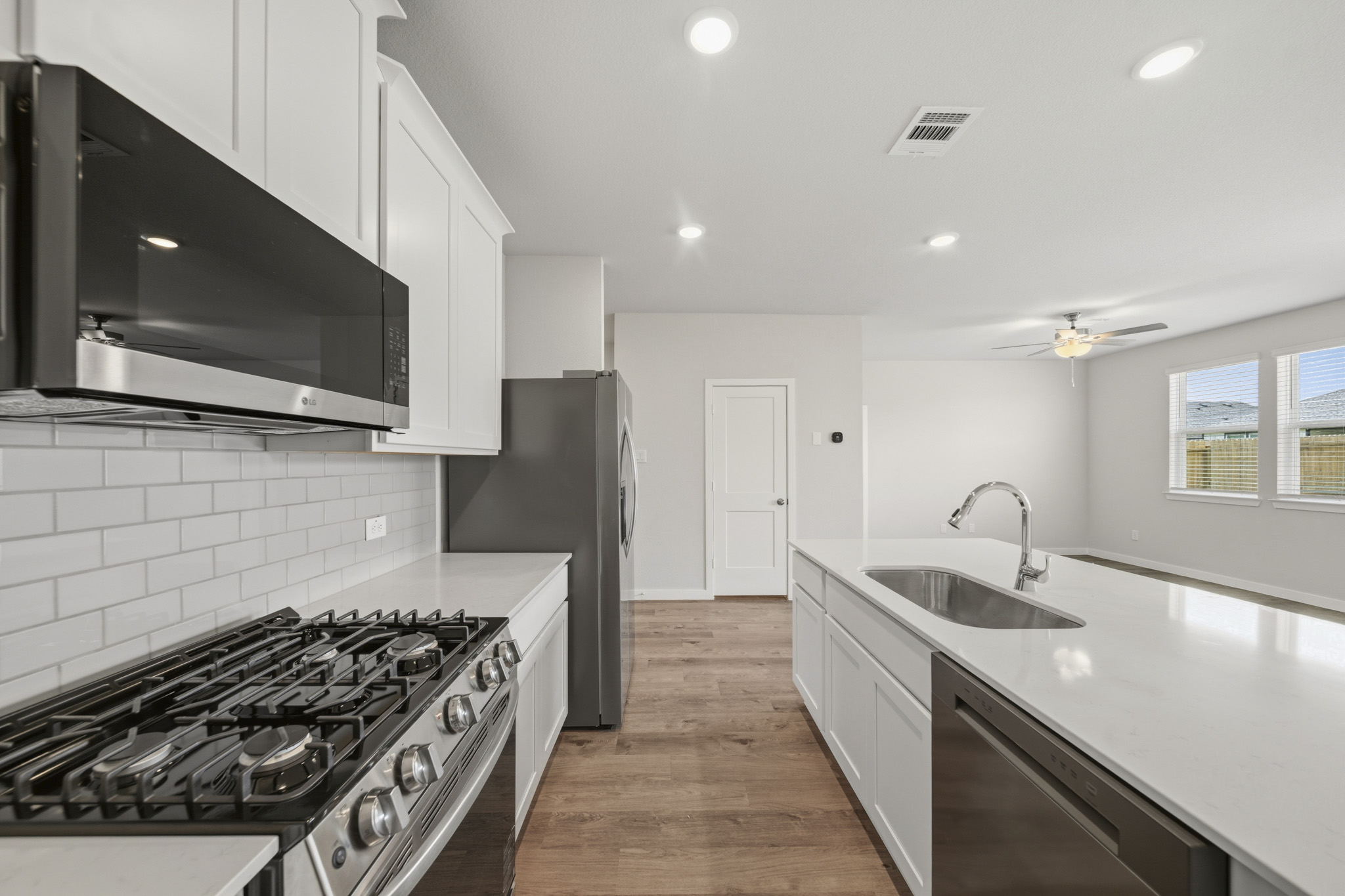 A kitchen with white cabinets.