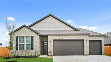 A house with a garage with American Gothic House in the background.