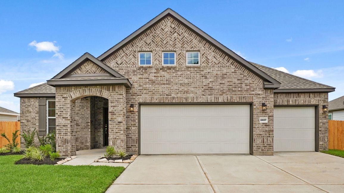 A house with garages and a driveway.
