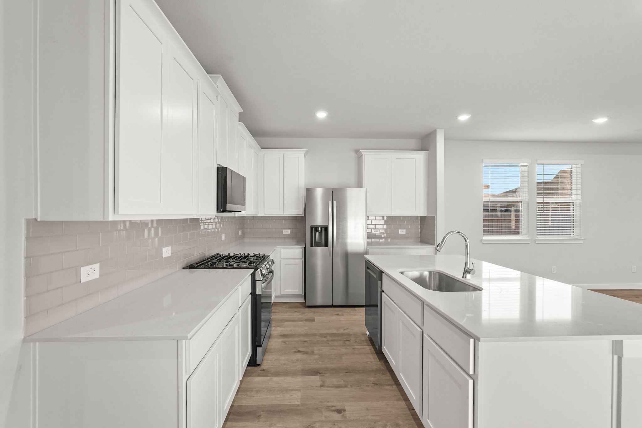 A kitchen with white cabinets.