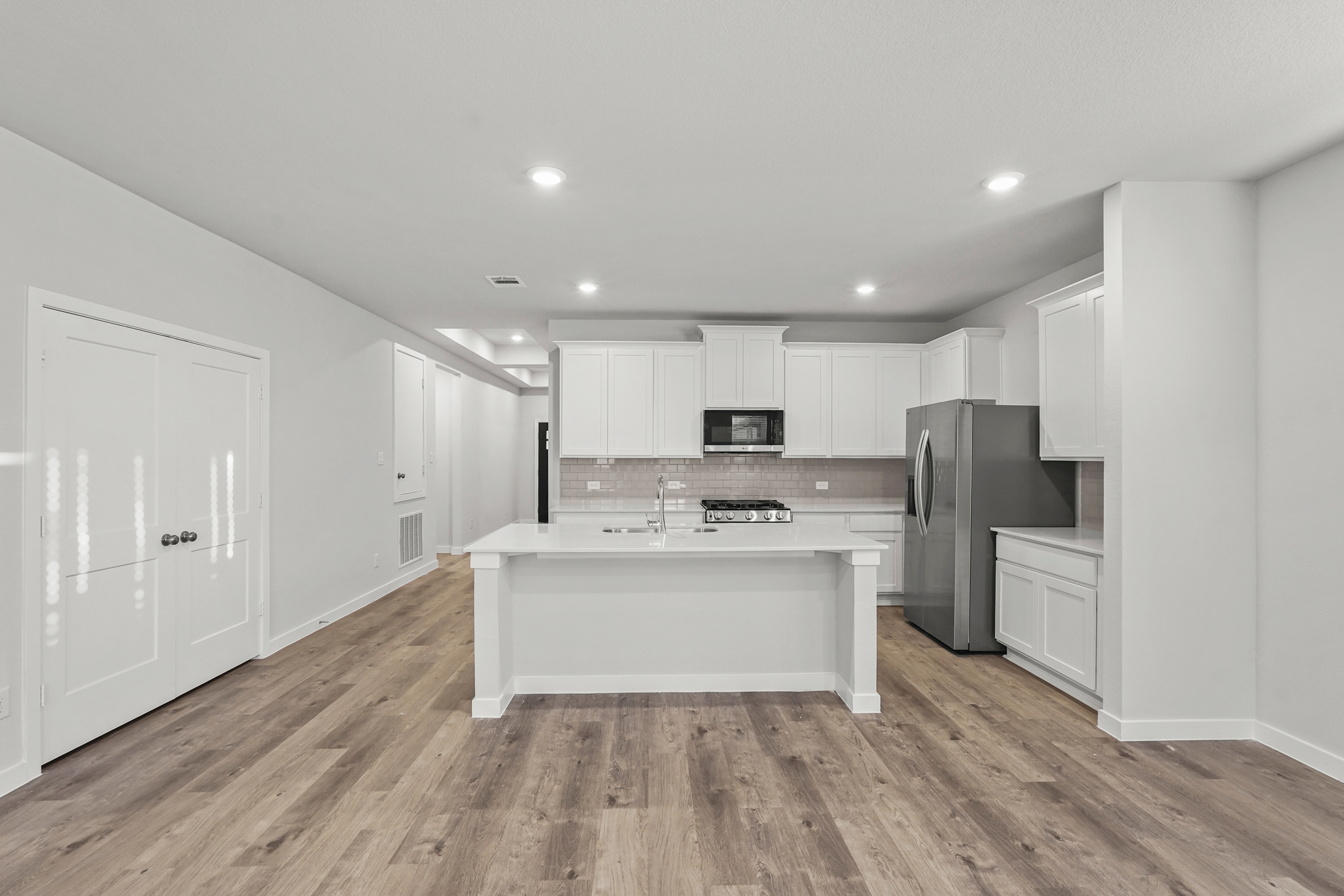 A kitchen with white cabinets.
