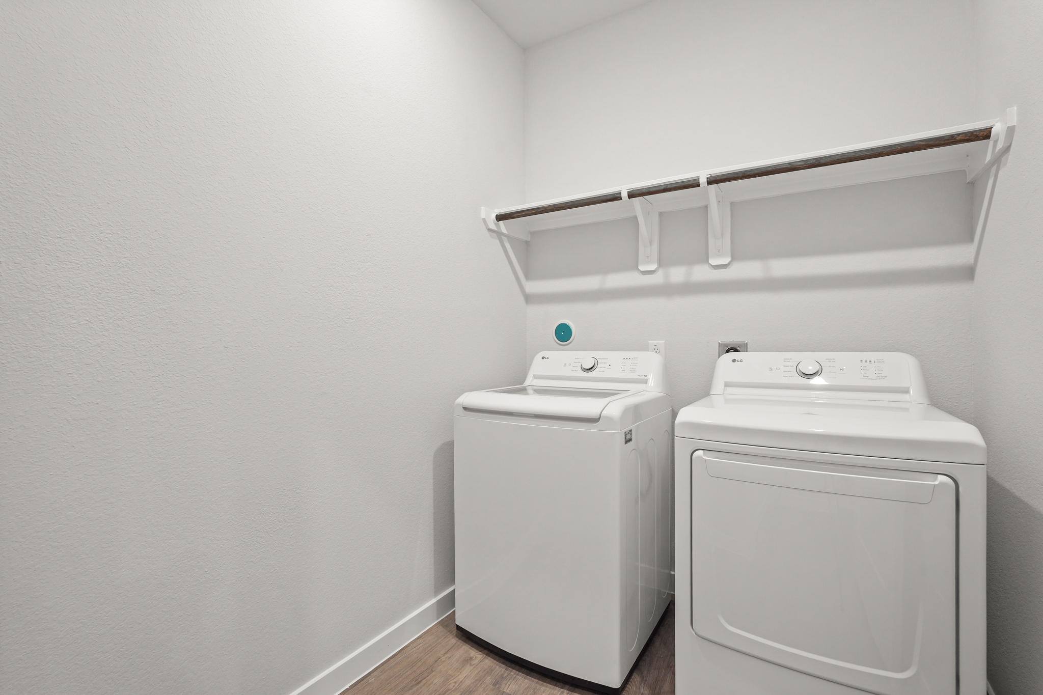 A washing machine and dryer in a room.