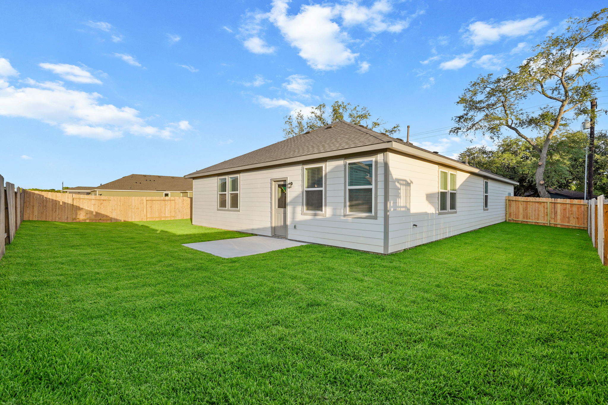 A house with a fence and grass.