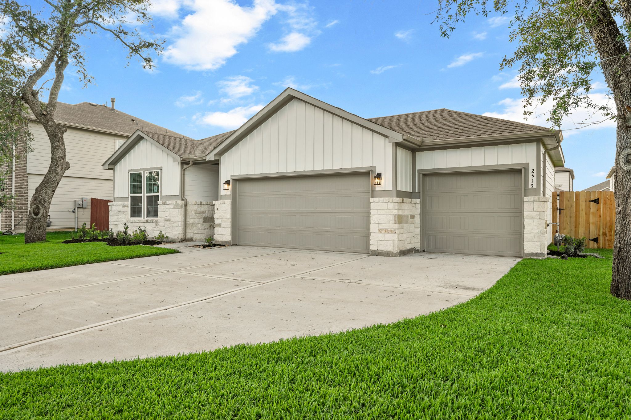A house with garages and grass.