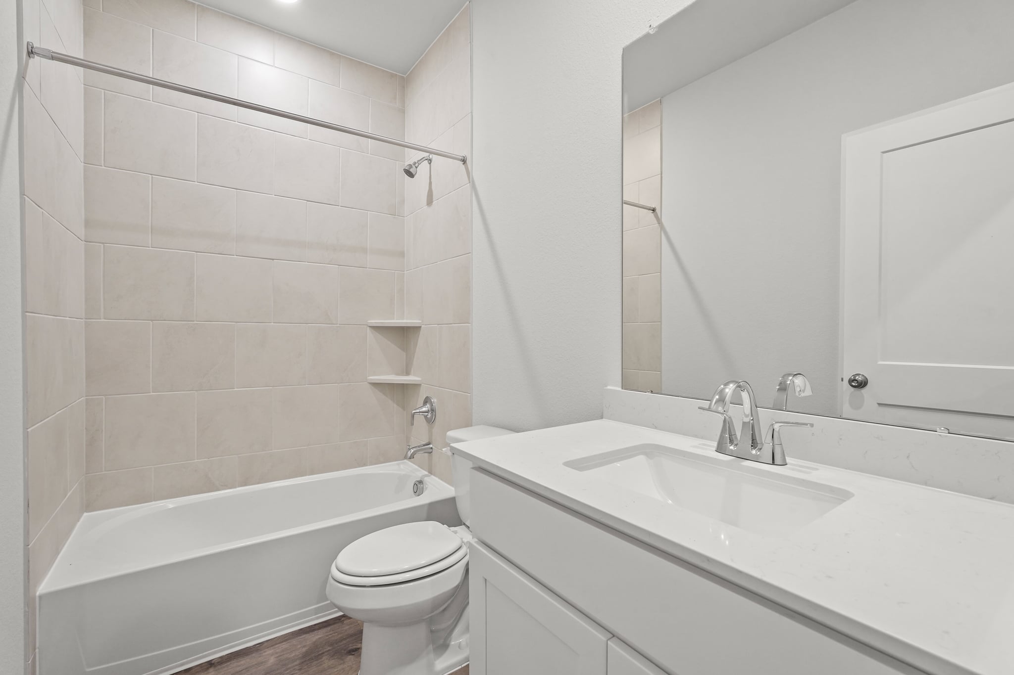 A bathroom with a tub sink and toilet.