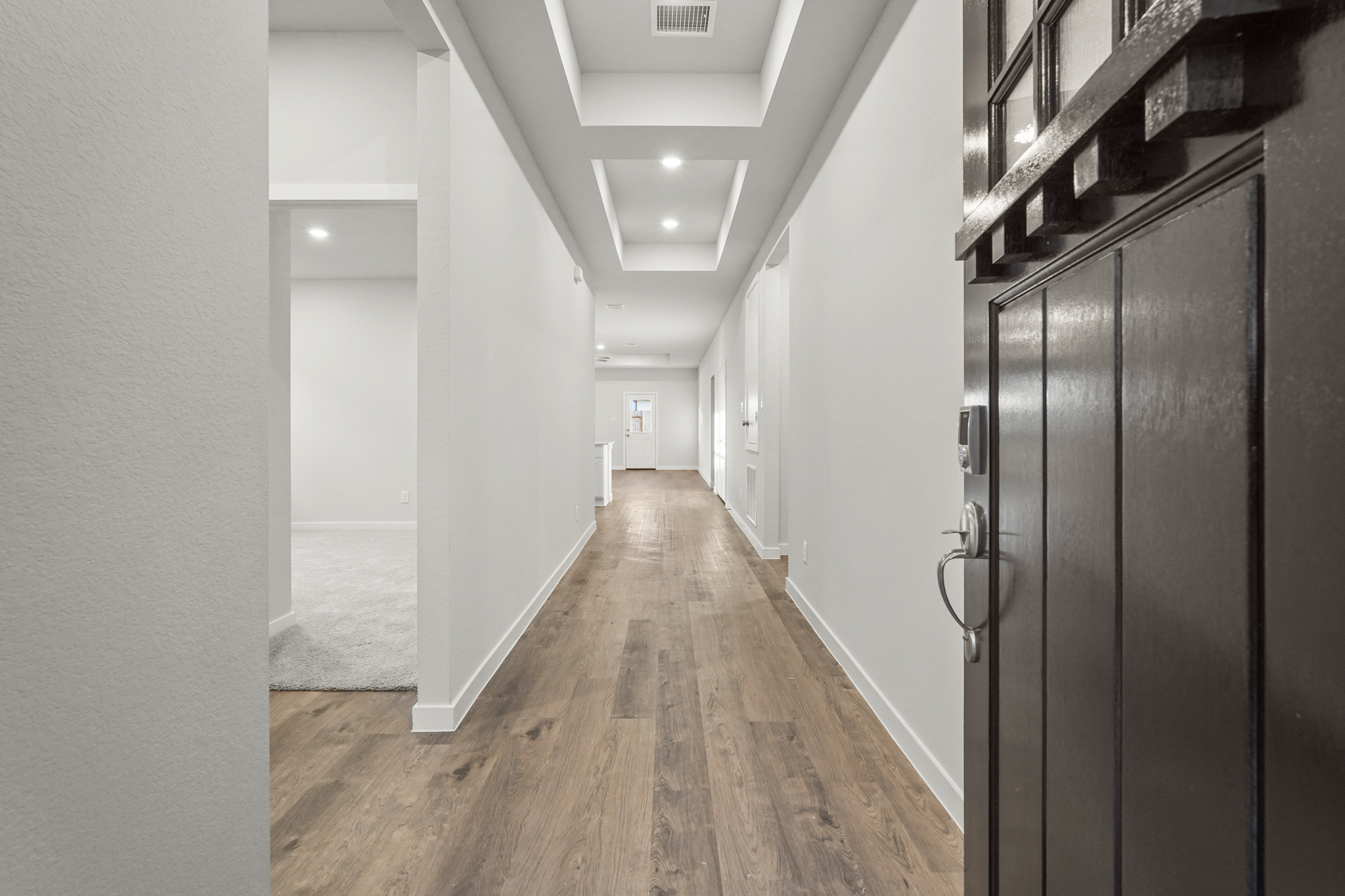 A hallway with black lockers.