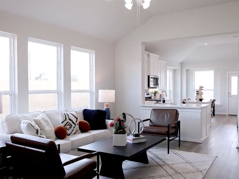 A living room with a white couch and a table.