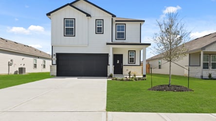 A white house with a driveway.