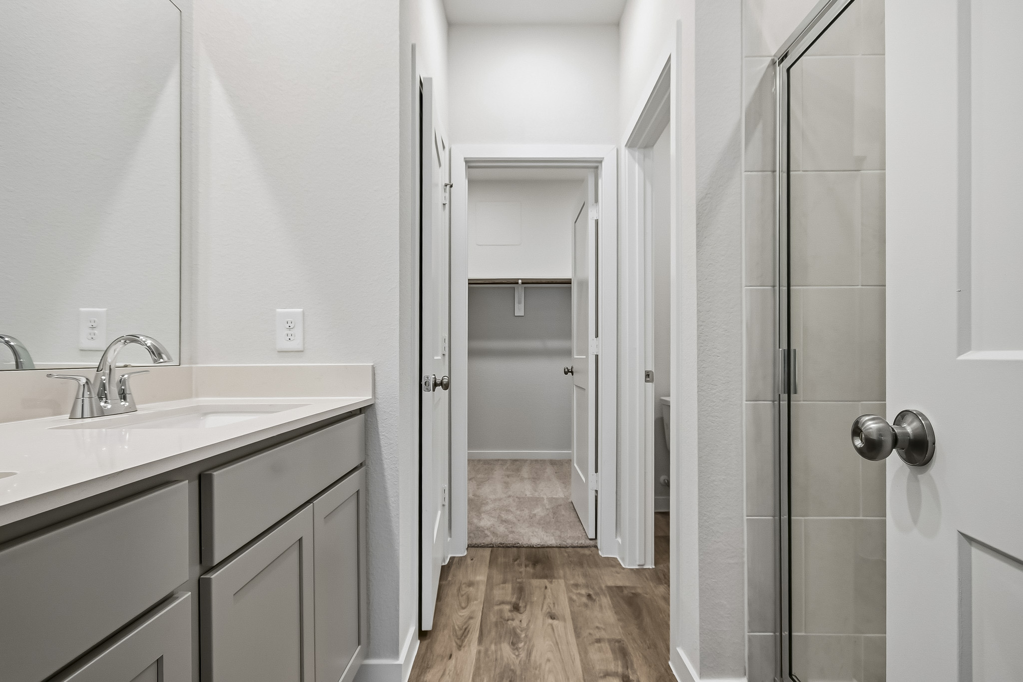 A bathroom with a sink and shower.
