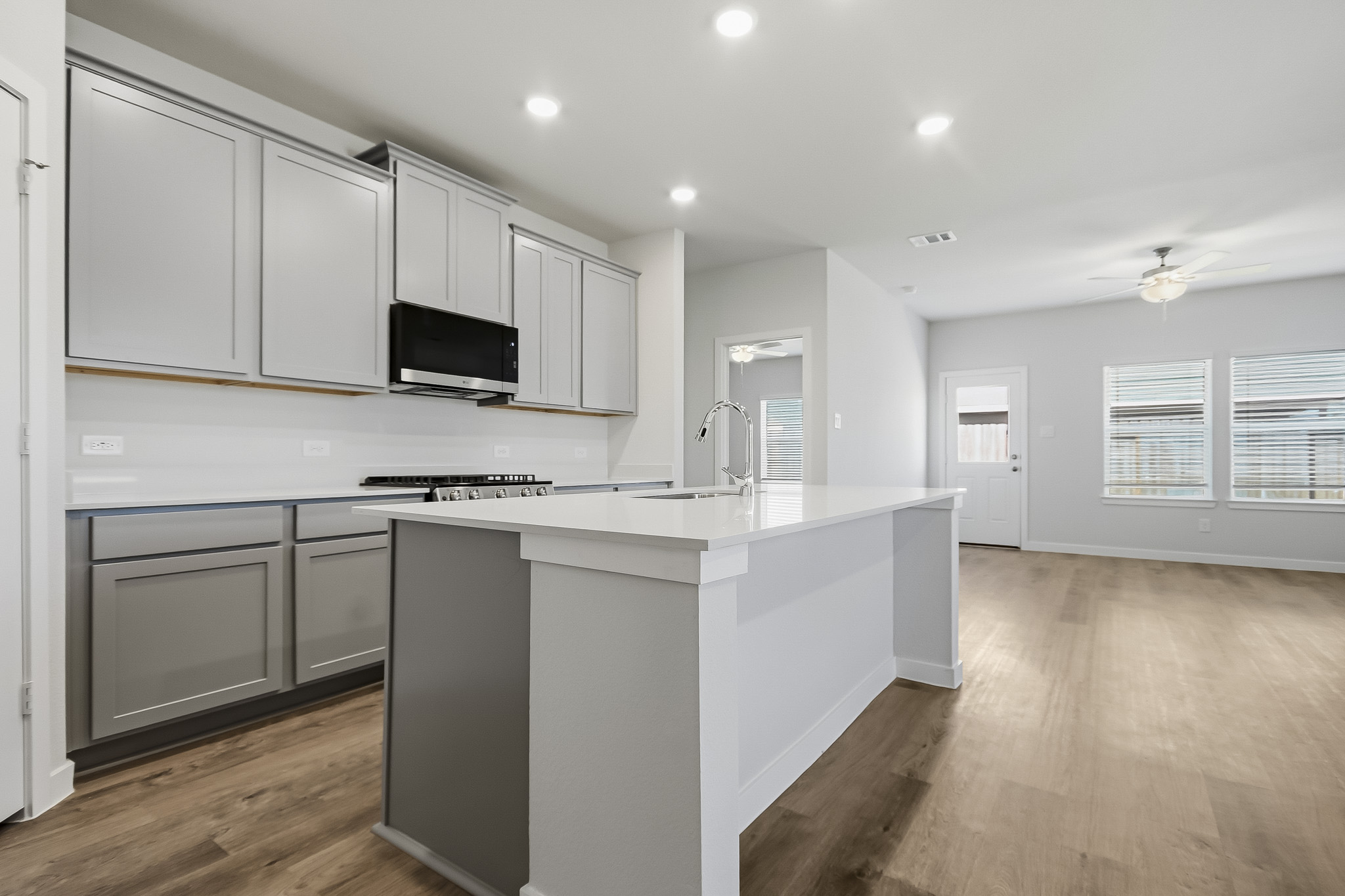 A kitchen with white cabinets.