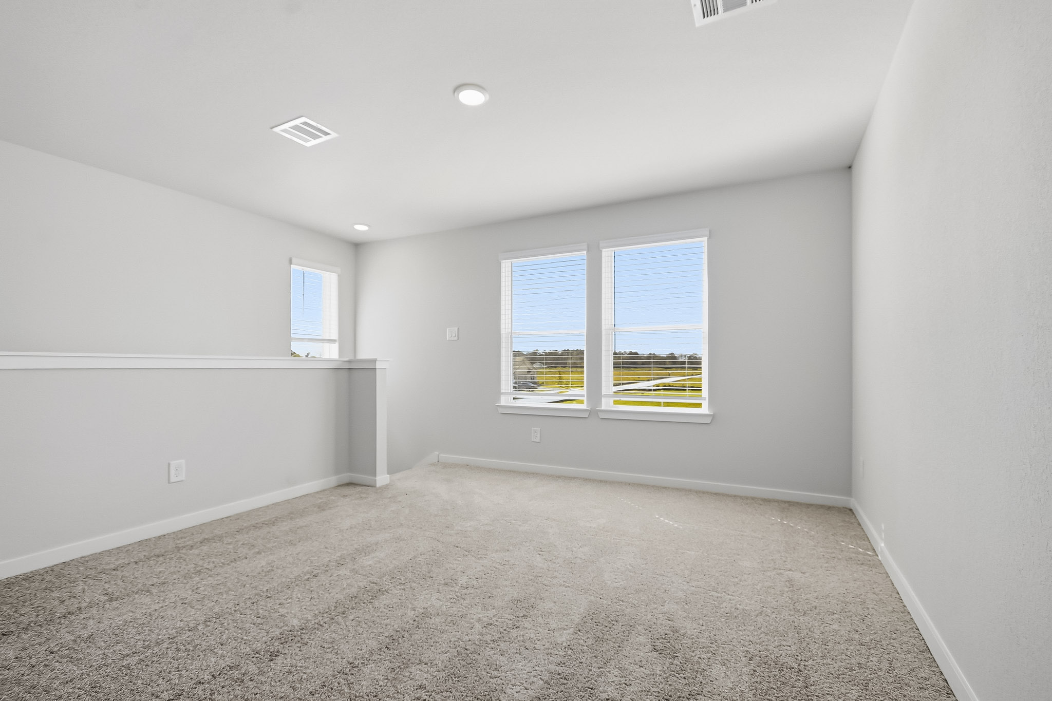A room with a window and a carpet.