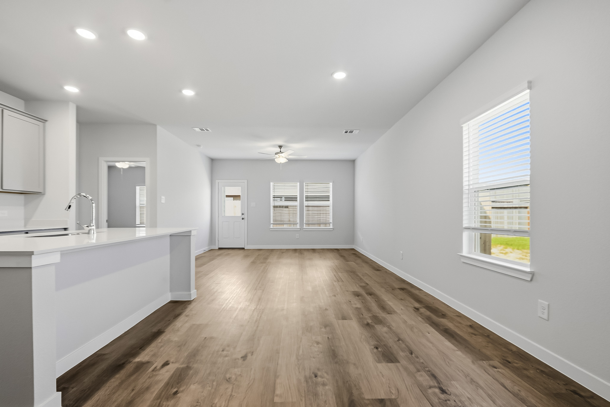 A kitchen with a wood floor.