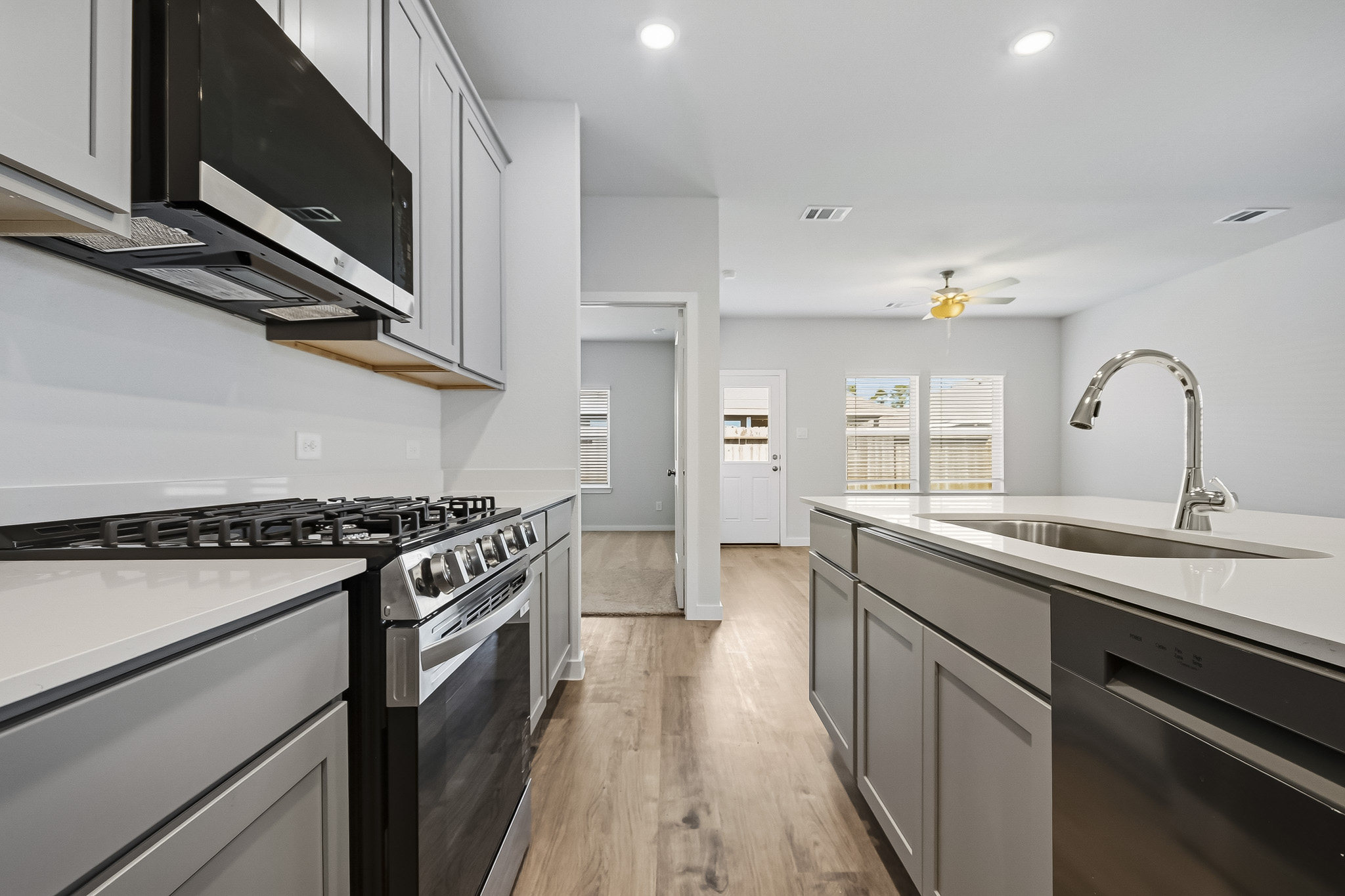 A kitchen with white cabinets.