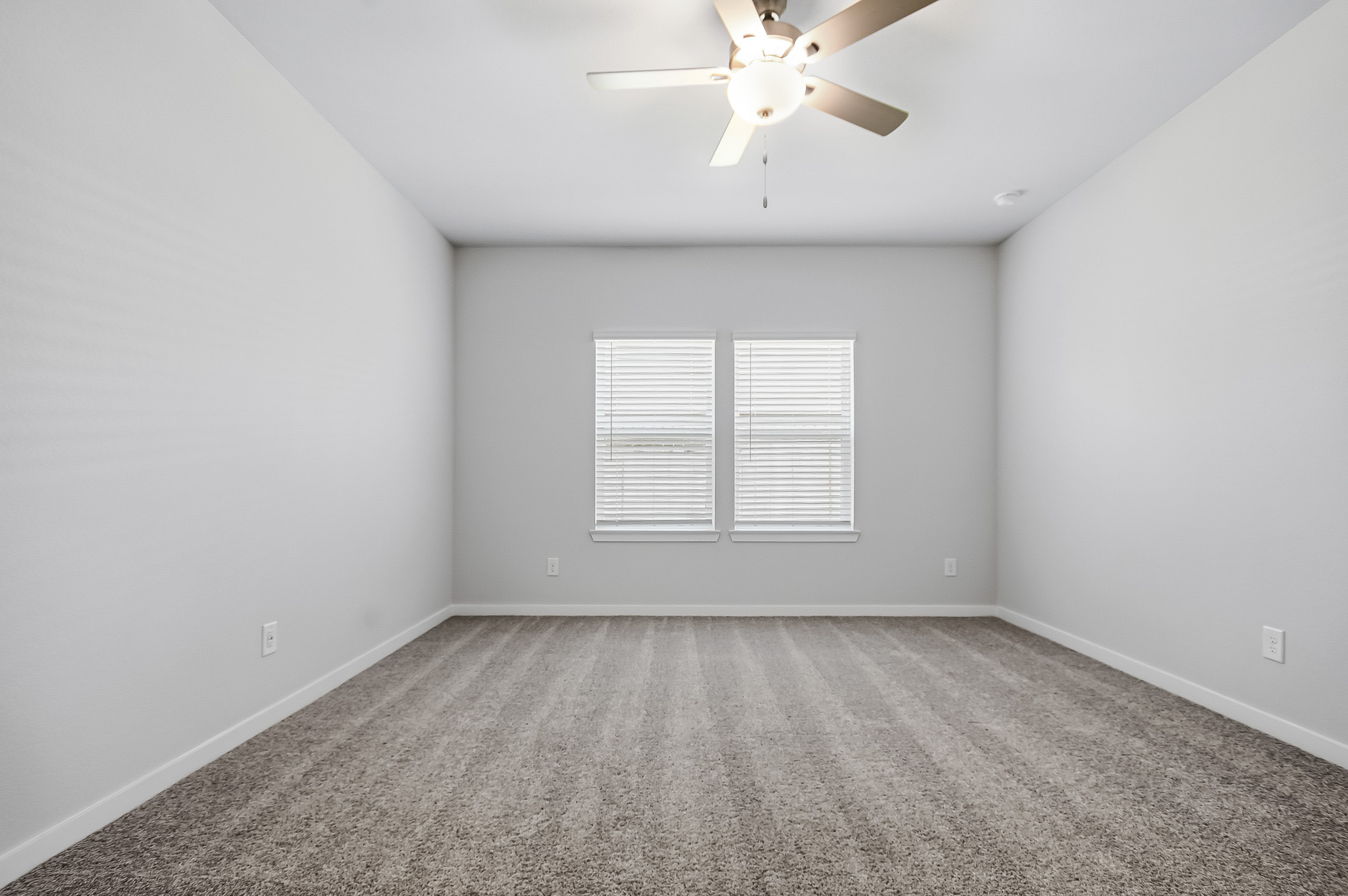 A room with a ceiling fan and a ceiling fan.