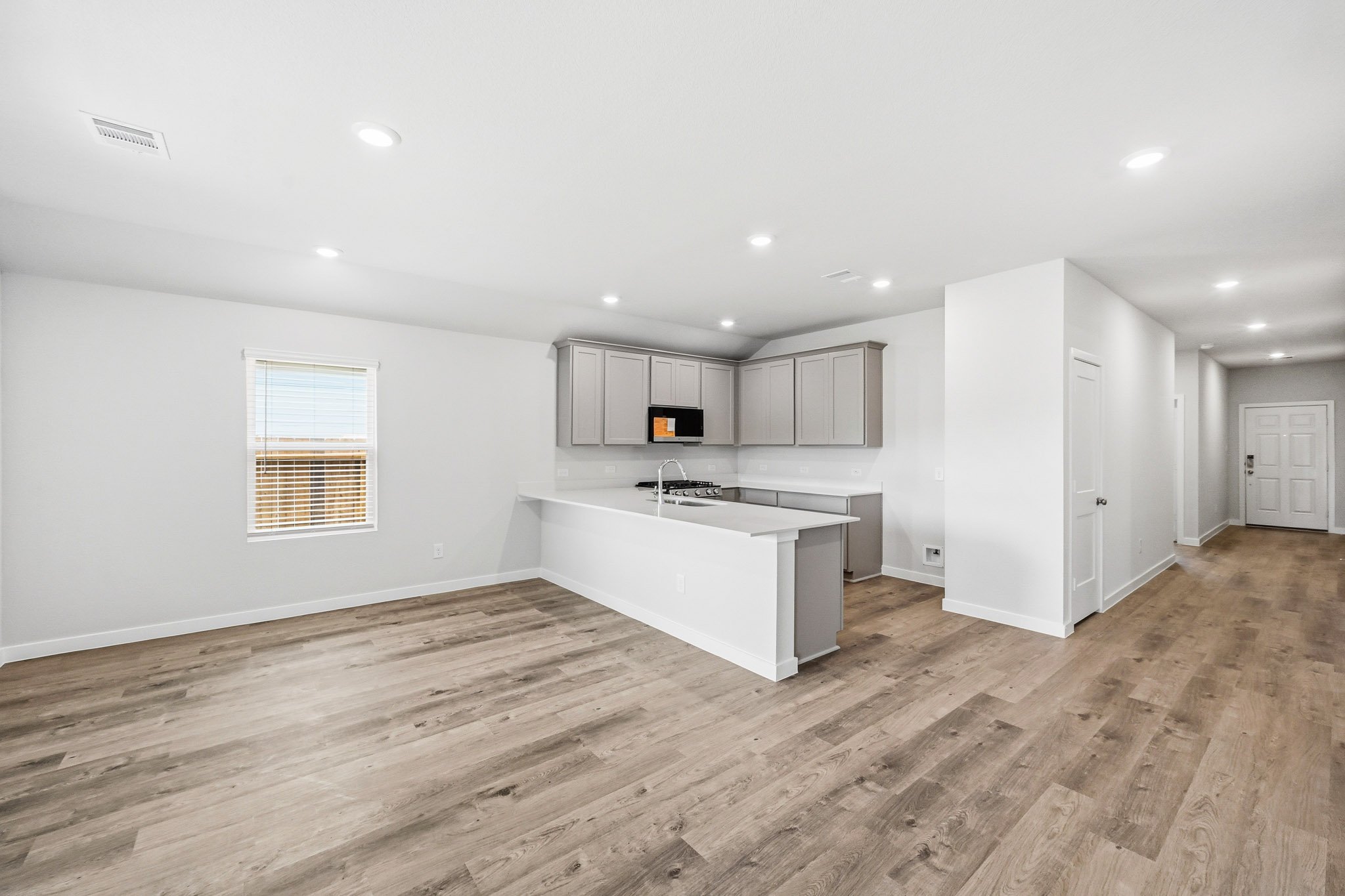 A kitchen with white cabinets.