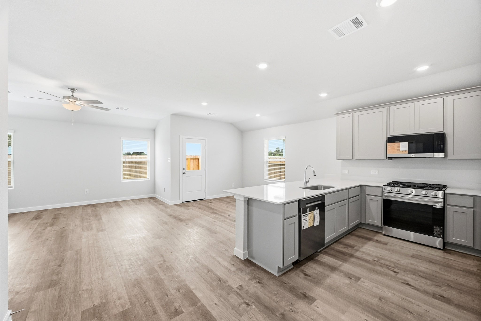 A kitchen with white cabinets.