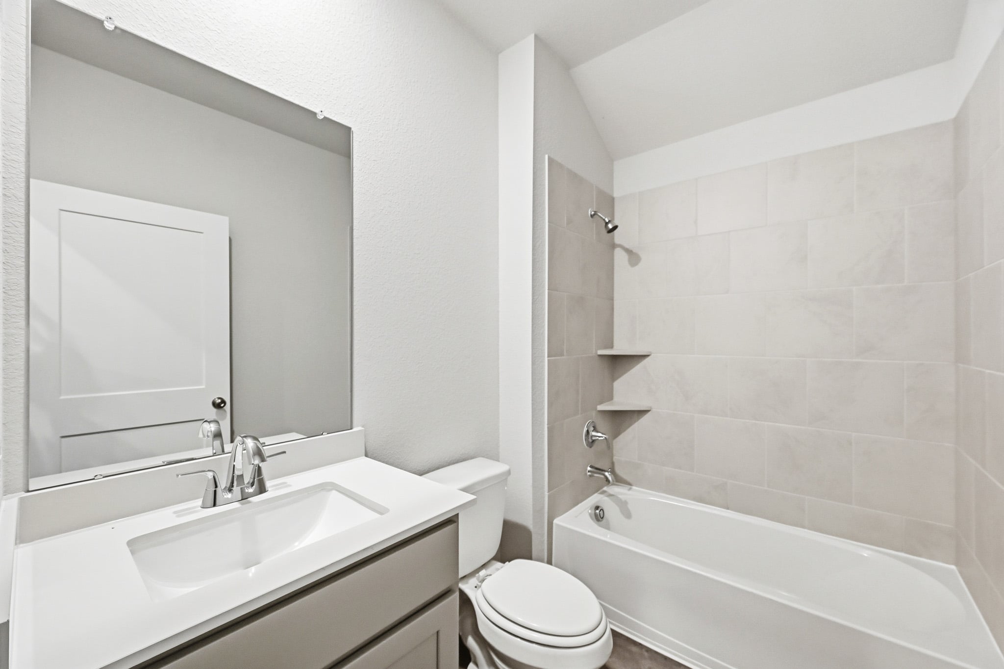 A bathroom with a sink toilet and bathtub.