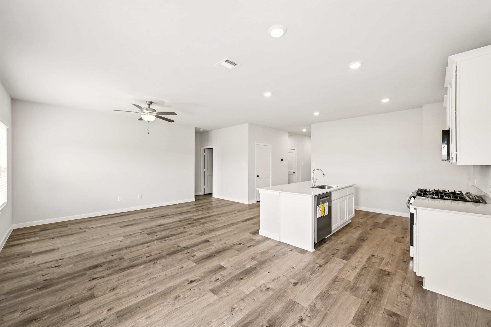 A kitchen with white cabinets.