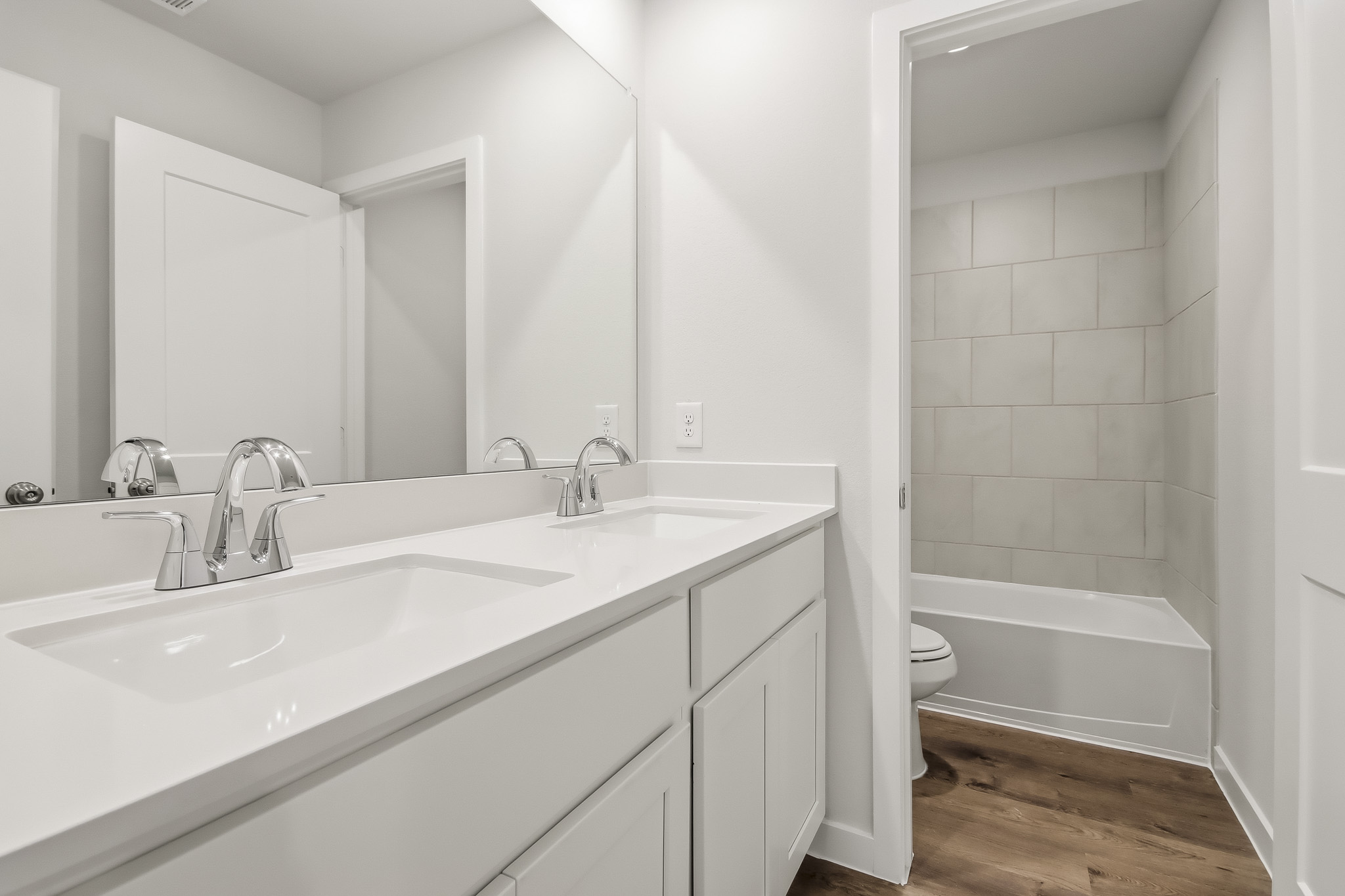 A bathroom with a tub sink and toilet.