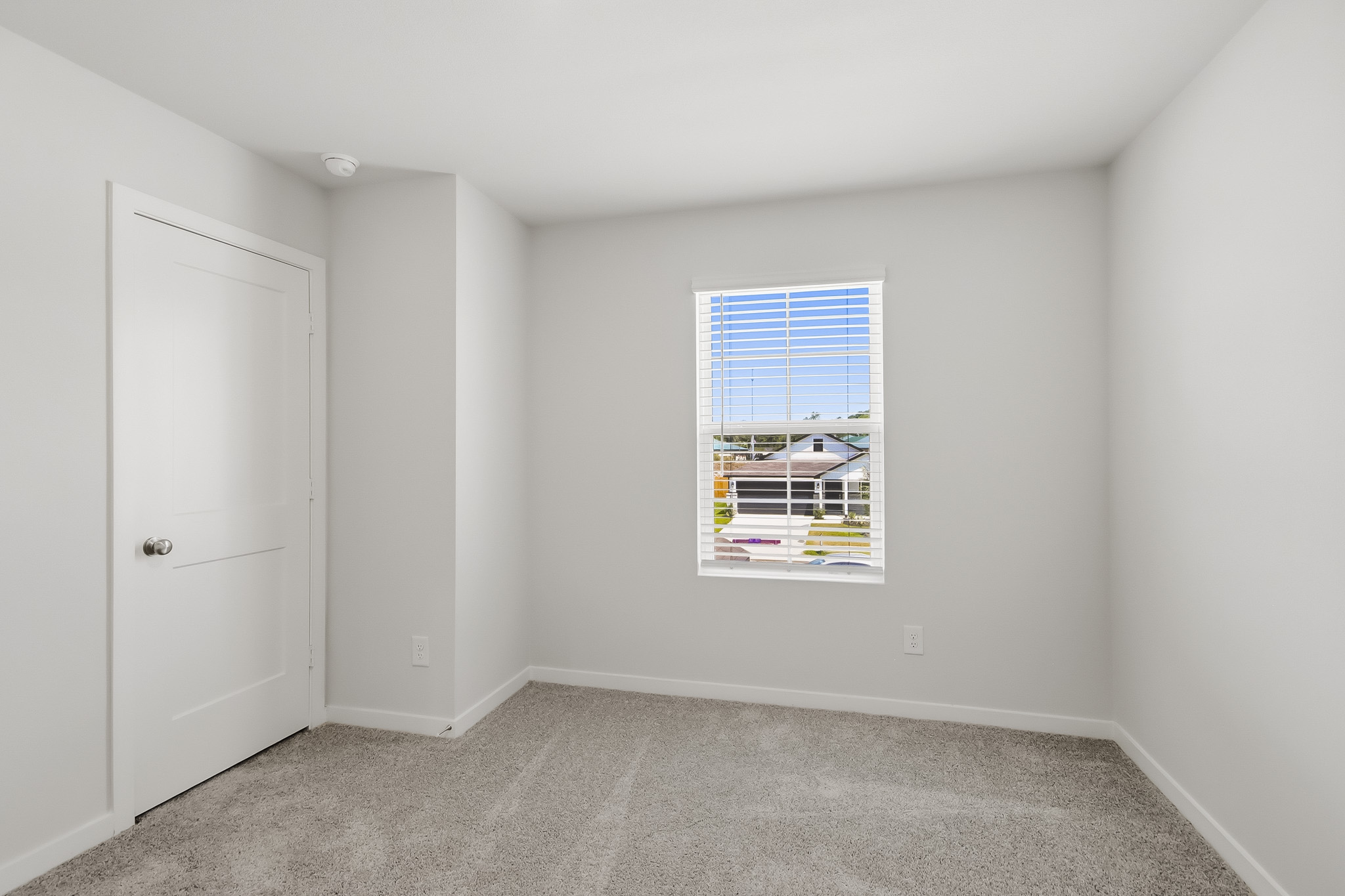 A room with a window and a door.