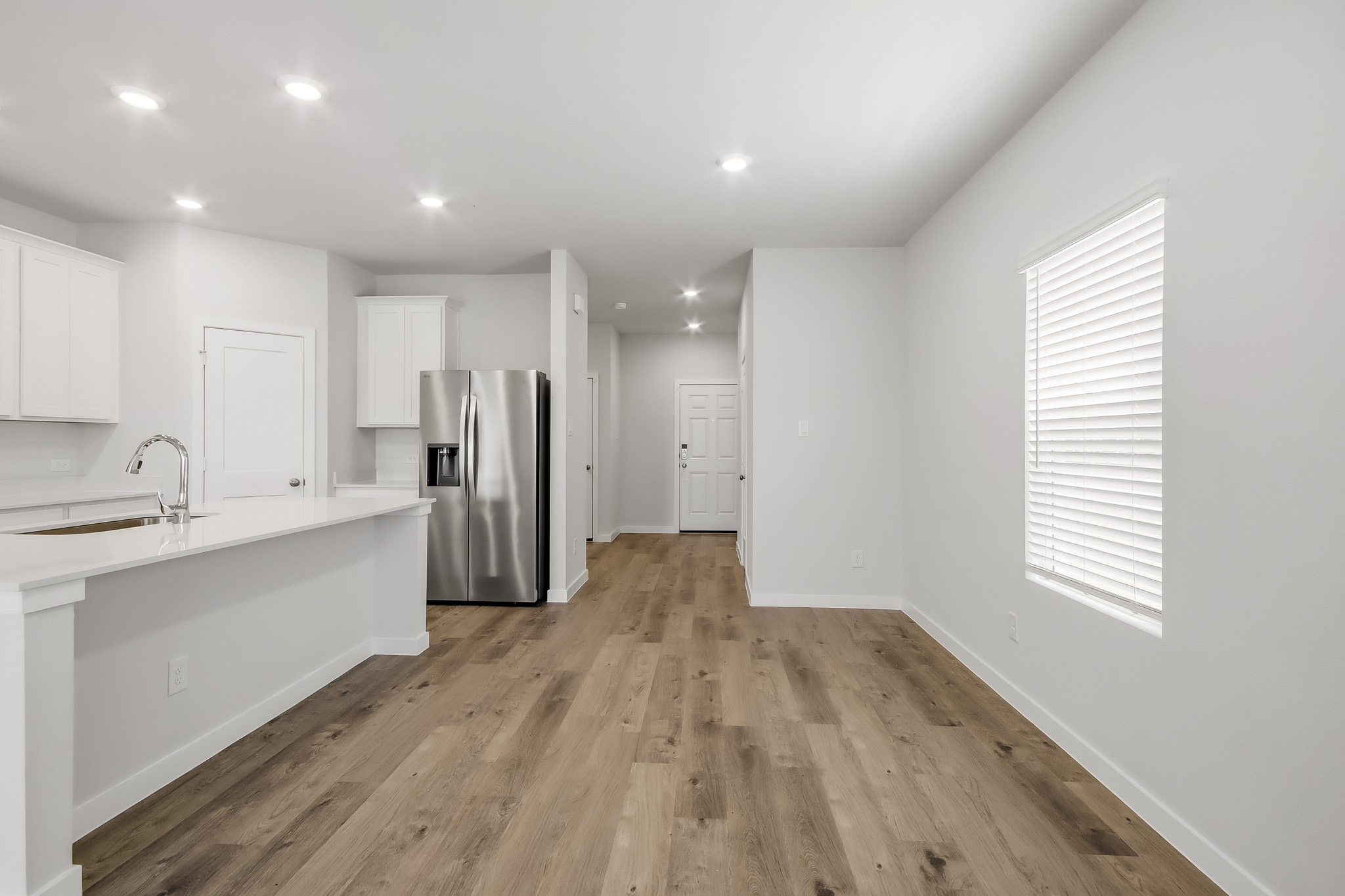 A kitchen with white cabinets.