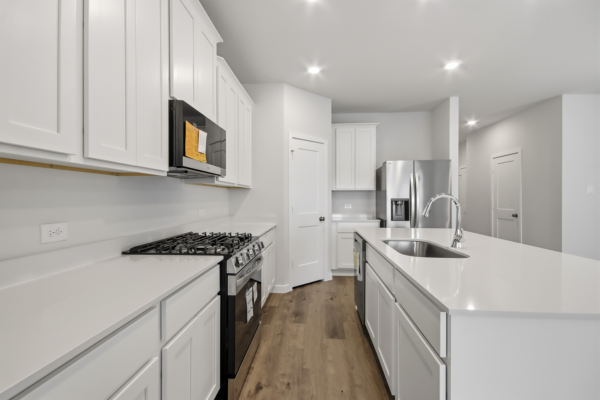 A kitchen with white cabinets.