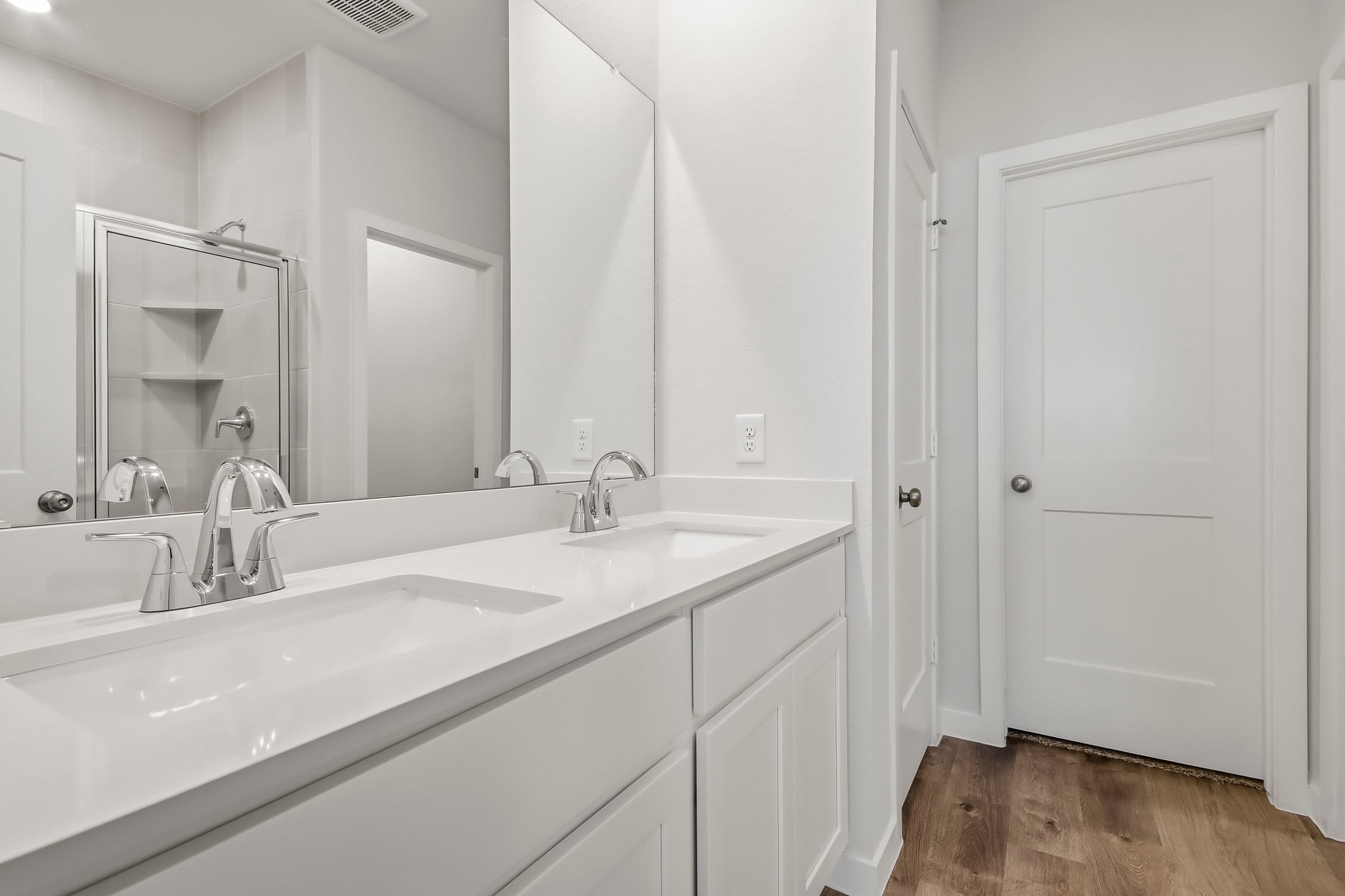 A bathroom with a large mirror.