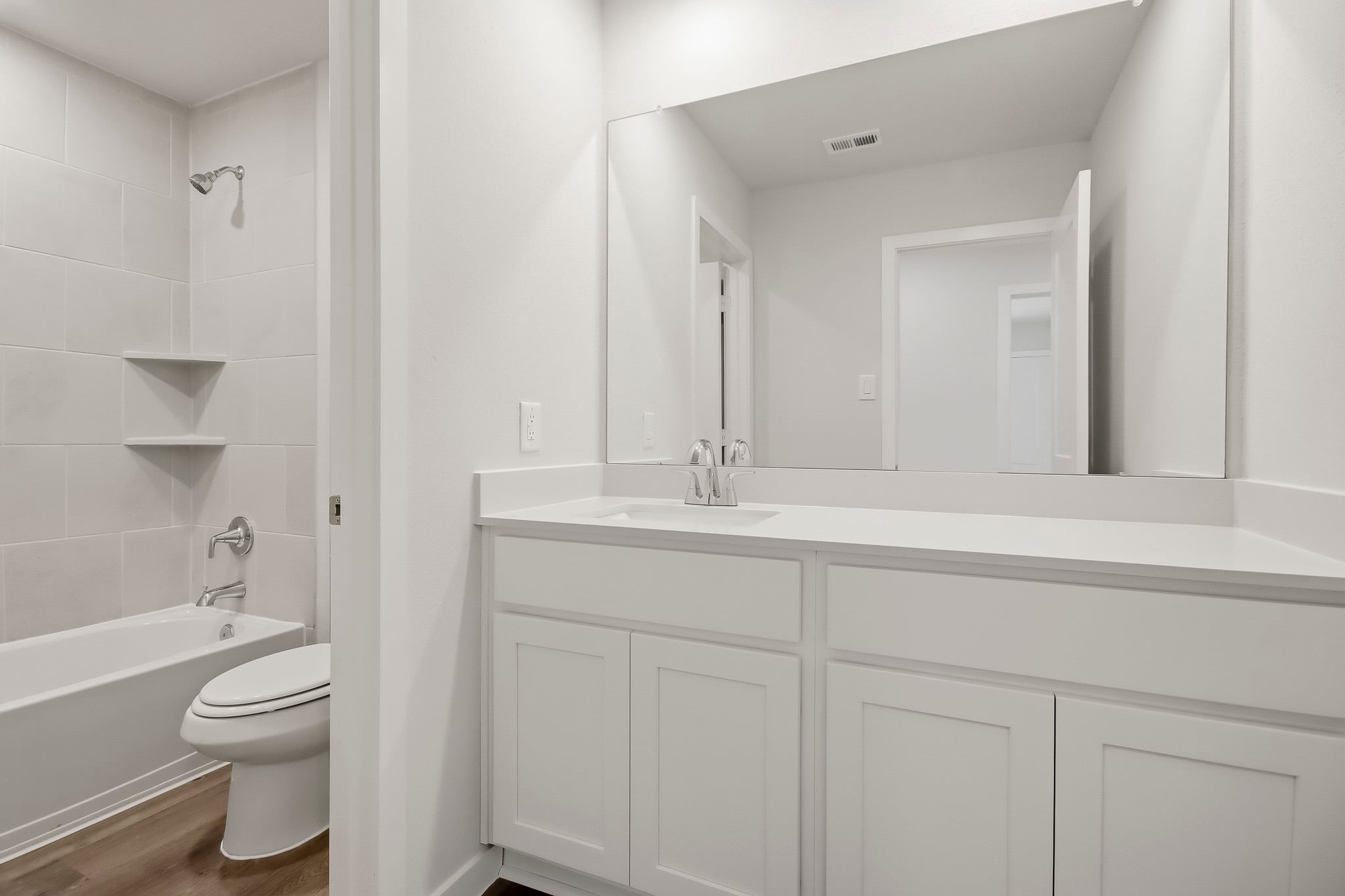 A bathroom with a sink toilet and bathtub.